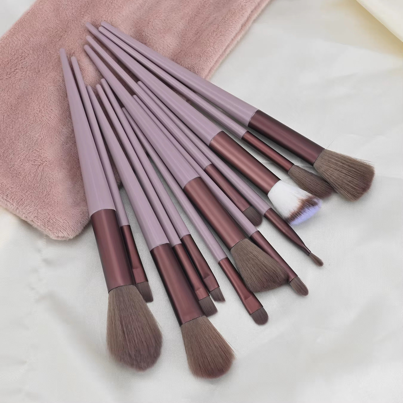 Complete 13 makeup brushes for face, eye, and foundation makeup in colorful display.